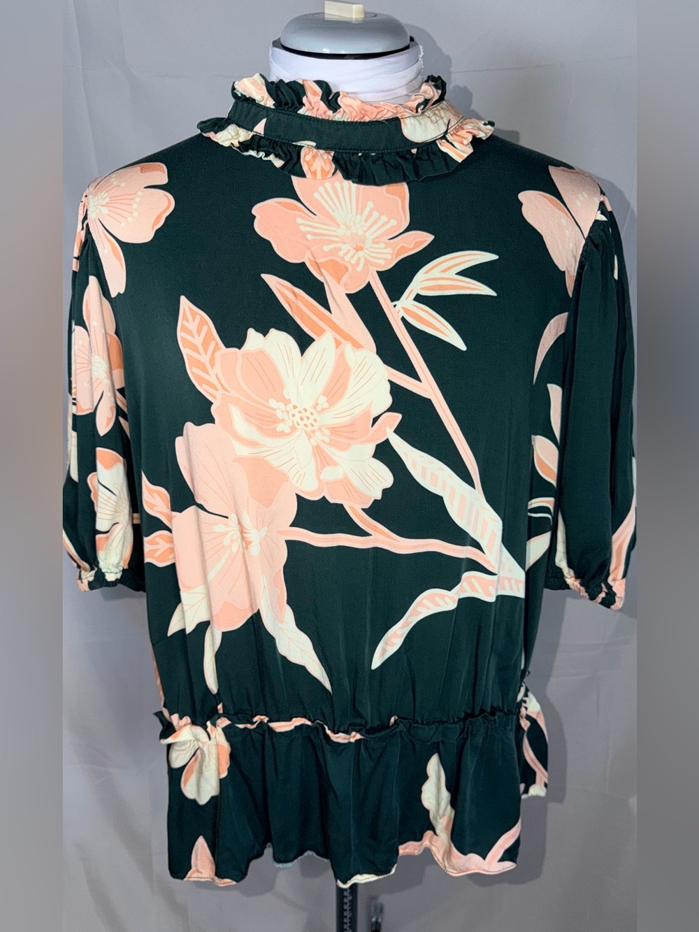 Tahari Floral Short sleeve top with a ruffle neck and peplum hem